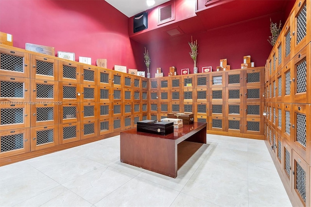 tiled office space with a high ceiling