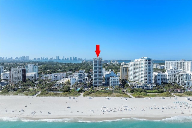 birds eye view of property with a view of the beach and a water view