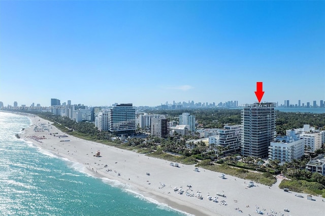 bird's eye view with a water view and a beach view