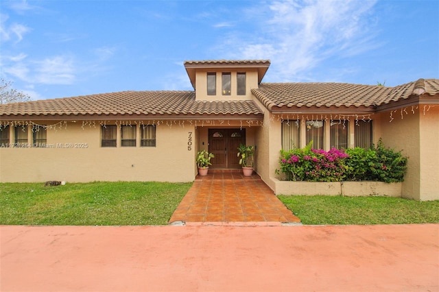 mediterranean / spanish-style home featuring a front lawn