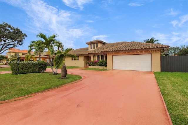 mediterranean / spanish house with a garage and a front lawn