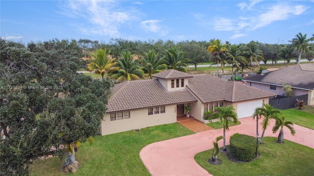 view of front of property featuring a garage and a front yard