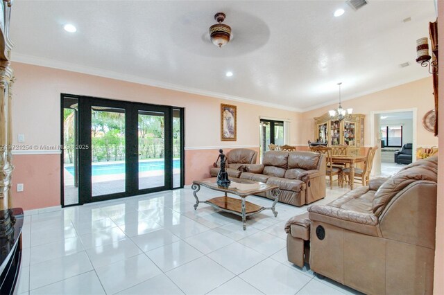 living room with ceiling fan, a healthy amount of sunlight, and ornamental molding