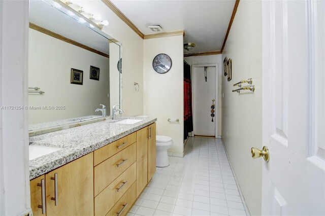 bathroom with tile patterned flooring, vanity, toilet, and ornamental molding