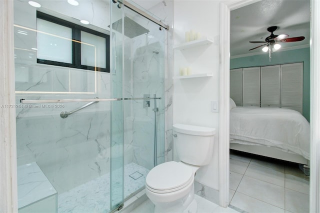 bathroom with ceiling fan, toilet, a shower with door, and crown molding