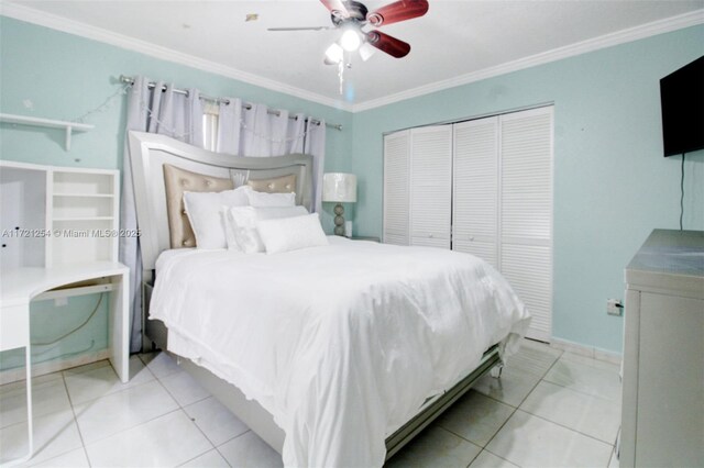 tiled bedroom with ceiling fan, ornamental molding, and a closet