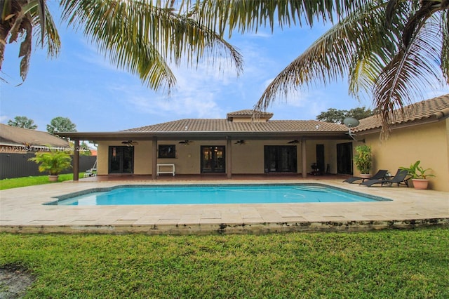 view of swimming pool featuring a patio area, ceiling fan, and a yard