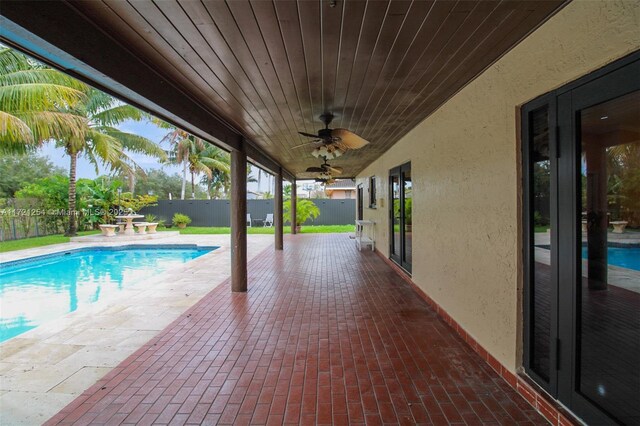 view of pool with a patio and ceiling fan