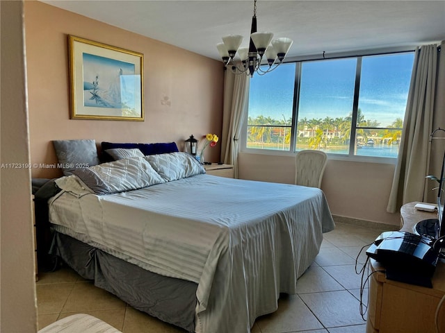 bedroom featuring light tile patterned floors and an inviting chandelier