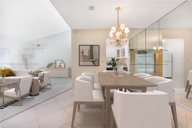 tiled dining space with a chandelier and lofted ceiling