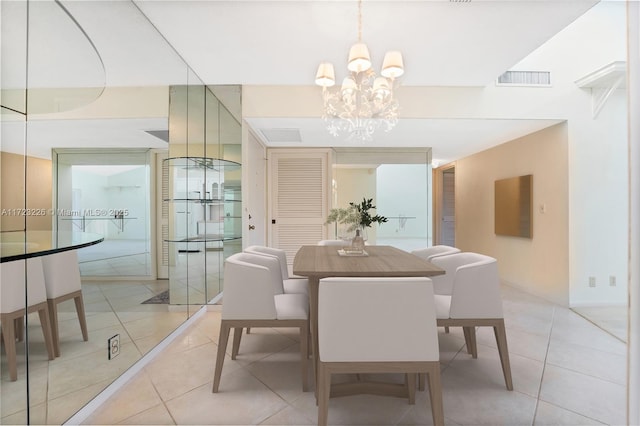 tiled dining space featuring a notable chandelier