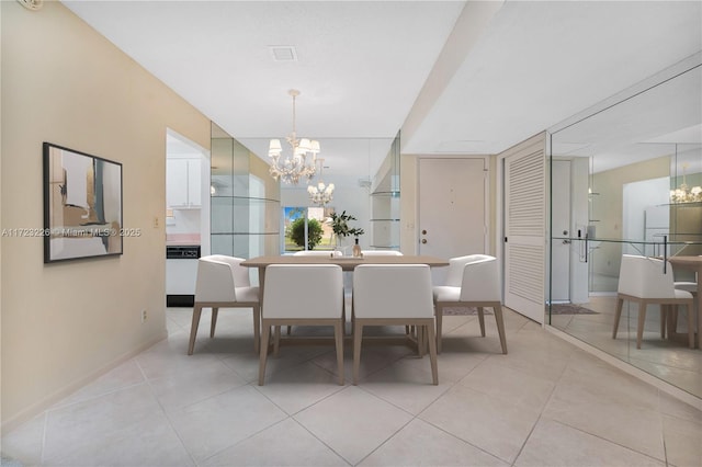 dining space with an inviting chandelier and light tile patterned flooring