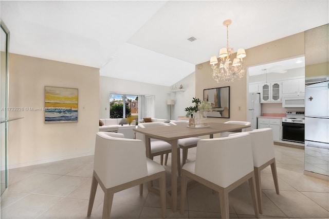 dining space with a notable chandelier, light tile patterned flooring, and lofted ceiling