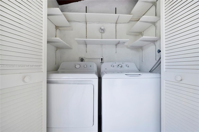 laundry area with washing machine and dryer