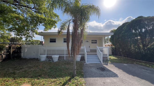 view of front facade with a porch and fence