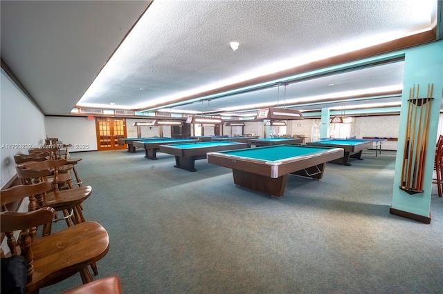 recreation room with carpet floors, a textured ceiling, and pool table