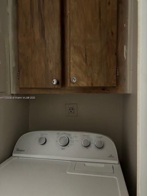 laundry area with cabinets and washer / dryer