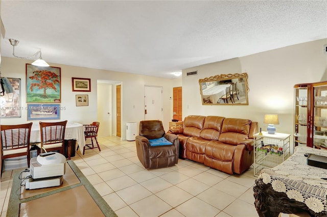 tiled living room featuring a textured ceiling