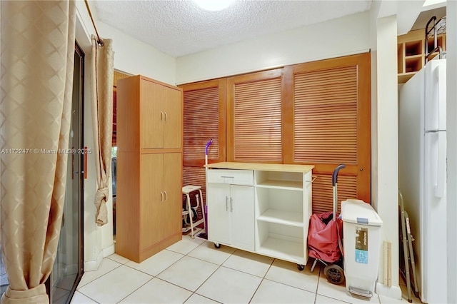 8860 SW 123rd Ct Unit K207, Miami, FL 33186 - interior space featuring light tile patterned floors and a textured ceiling