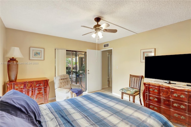 8860 SW 123rd Ct Unit K207, Miami, FL 33186 - bedroom featuring a textured ceiling, access to exterior, baseboards, and visible vents