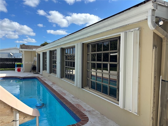 view of pool with a fenced in pool, fence, and a patio