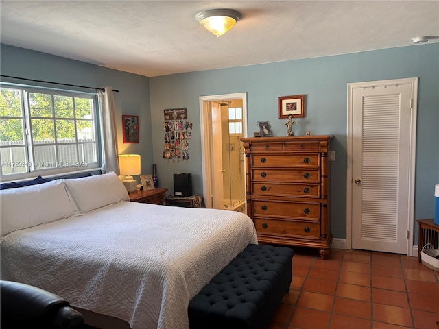 bedroom featuring dark tile patterned flooring and baseboards