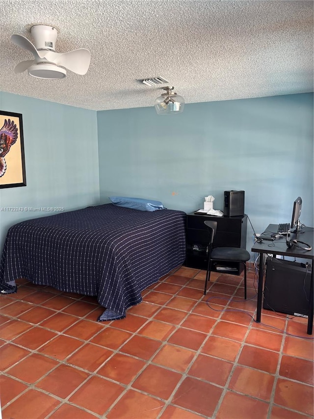 bedroom featuring a textured ceiling, tile patterned flooring, and visible vents