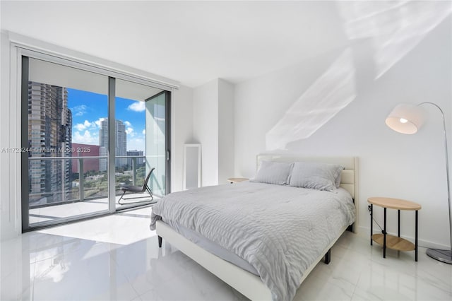 bedroom featuring access to exterior and a wall of windows