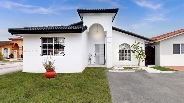 mediterranean / spanish house with a front yard