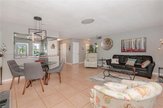 tiled living room featuring a textured ceiling