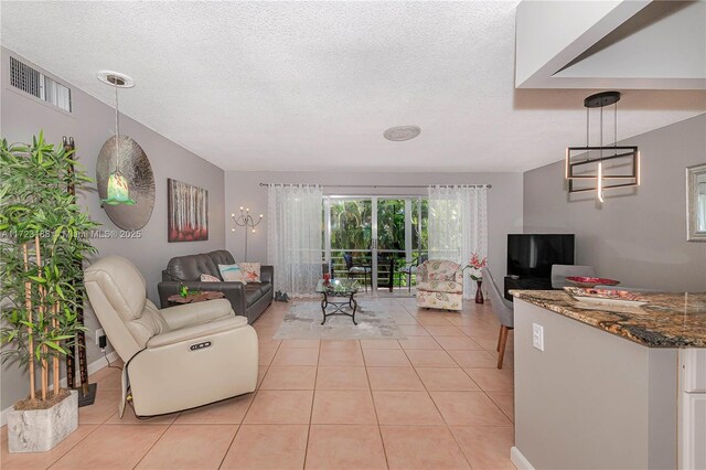 tiled living room featuring a textured ceiling