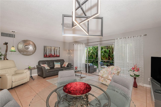 400 NE 14th Ave Unit 214, Hallandale Beach, FL 33009 - living area featuring a textured ceiling, light tile patterned flooring, visible vents, and baseboards