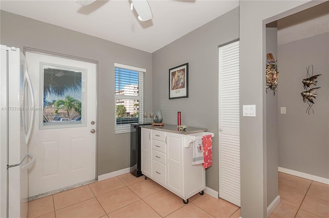 400 NE 14th Ave Unit 214, Hallandale Beach, FL 33009 - doorway to outside featuring a ceiling fan, baseboards, and light tile patterned floors