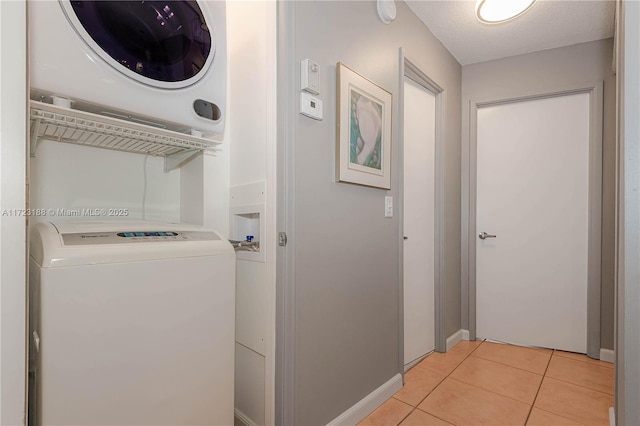 400 NE 14th Ave Unit 214, Hallandale Beach, FL 33009 - laundry area with light tile patterned floors, laundry area, a textured ceiling, and washer / dryer
