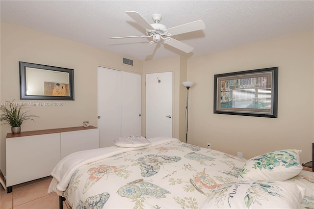 400 NE 14th Ave Unit 214, Hallandale Beach, FL 33009 - bedroom with a textured ceiling, ceiling fan, light tile patterned floors, visible vents, and a closet