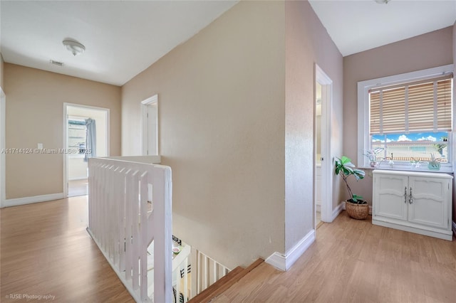 corridor with light hardwood / wood-style floors