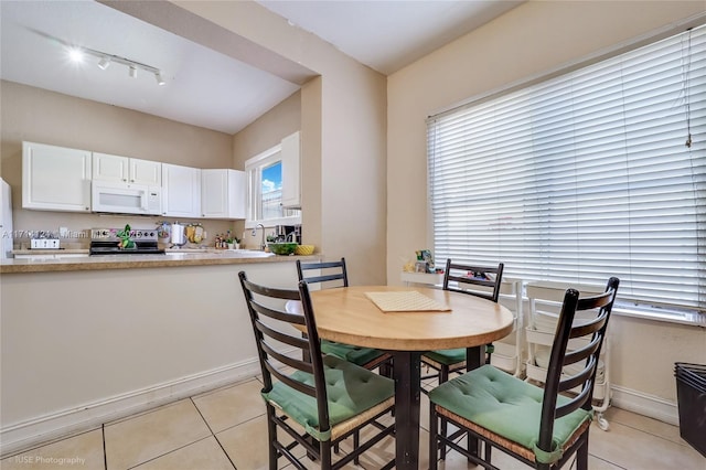 dining area with light tile patterned floors