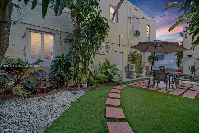 yard at dusk with a patio area