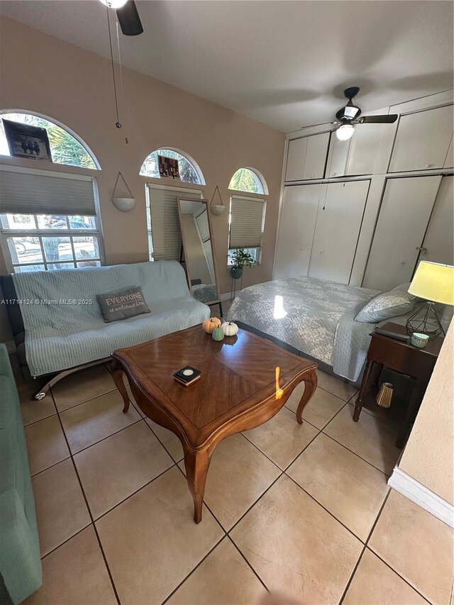 living room with ceiling fan and light tile patterned floors