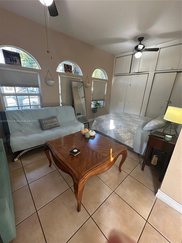 tiled living room with ceiling fan