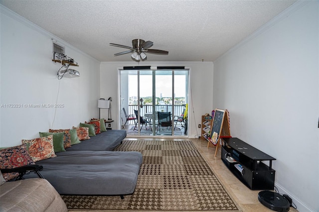 living room featuring crown molding, ceiling fan, and a textured ceiling