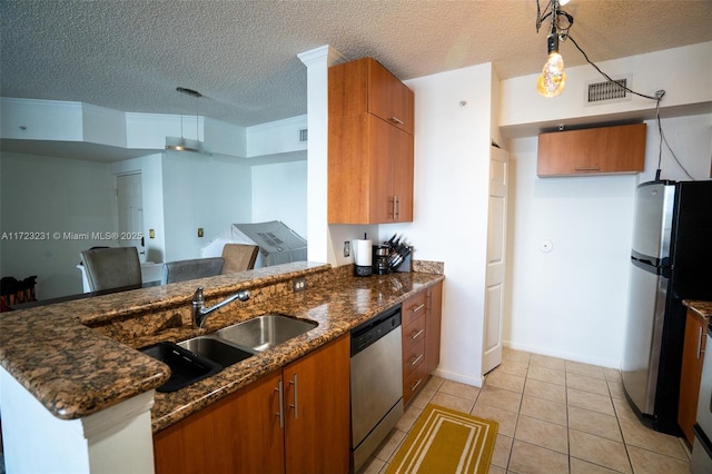 kitchen with hanging light fixtures, appliances with stainless steel finishes, dark stone countertops, and kitchen peninsula