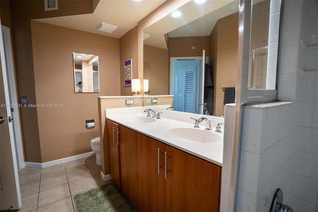 bathroom with vanity, tile patterned floors, and toilet