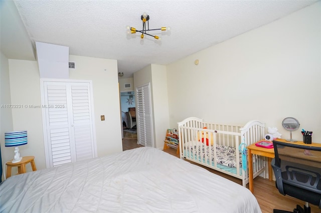 bedroom with hardwood / wood-style flooring, a closet, and a textured ceiling