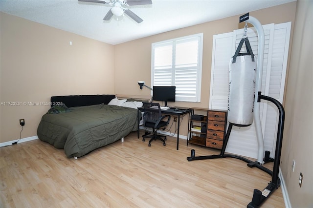 bedroom with ceiling fan and light hardwood / wood-style floors