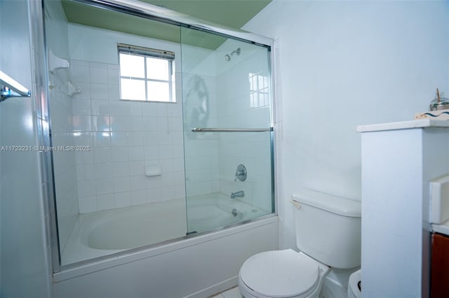 bathroom featuring shower / bath combination with glass door and toilet