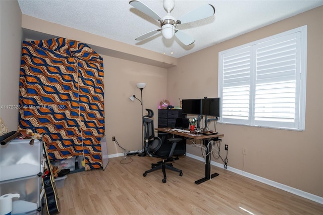 office area featuring ceiling fan, a textured ceiling, and light wood-type flooring