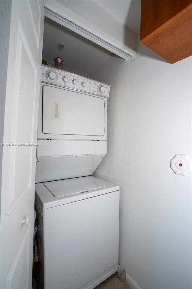 clothes washing area with stacked washer / drying machine