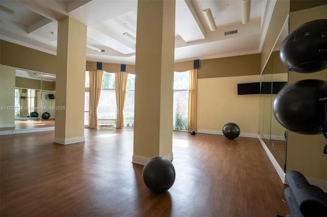 workout room with ornamental molding and wood-type flooring