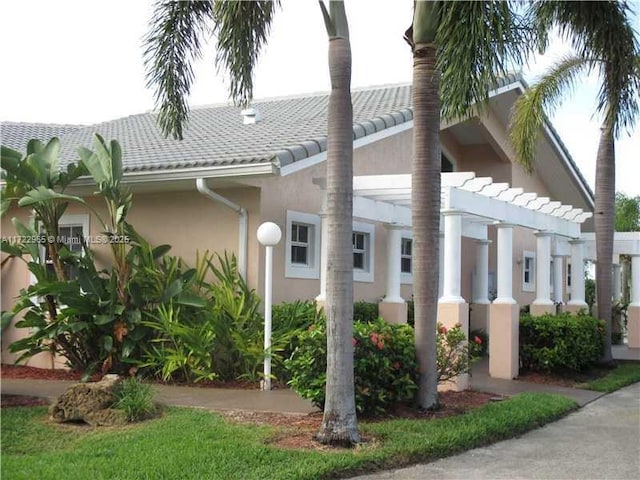 21340 NE 8th Ct Unit 1, Miami, FL 33179 - view of home's exterior with stucco siding and a tiled roof